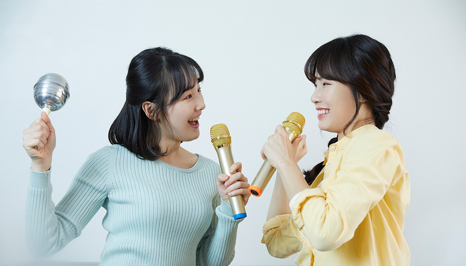 Two women enjoying karaoke together